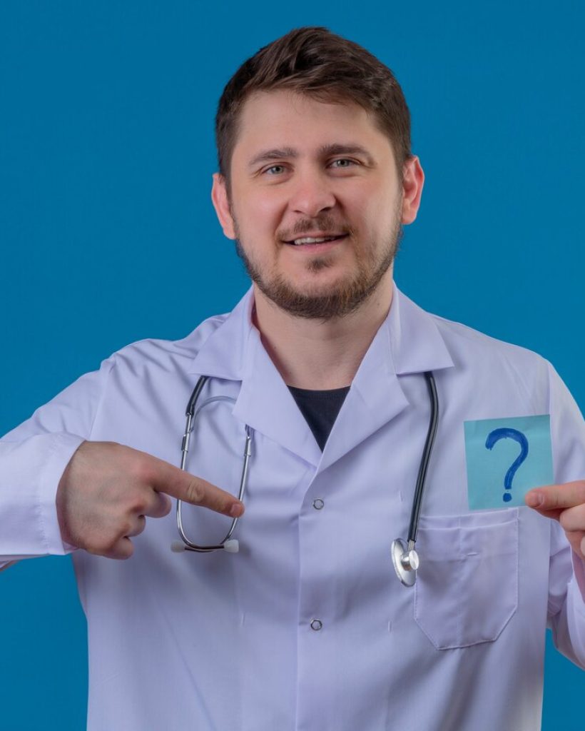 young-man-doctor-wearing-white-coat-stethoscope-holding-paper-with-question-mark-with-smile-face-pointing-finger-himself-isolated-blue-background_141793-12572